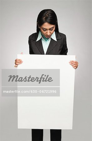 Businesswoman holding a placard