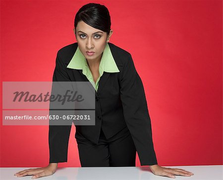 Portrait of a businesswoman standing at a conference table