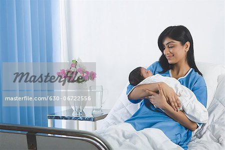 Woman with her baby on the bed
