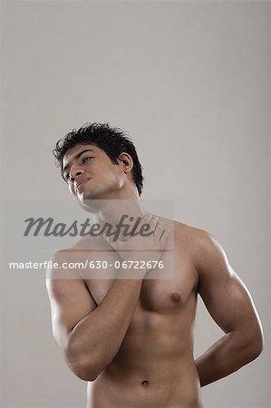 Muscular man suffering from neckache
