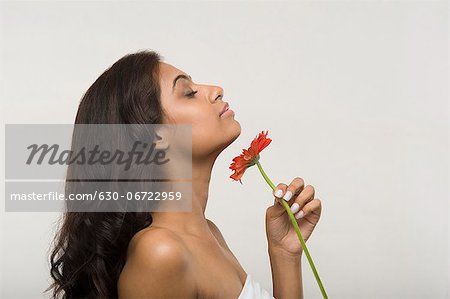 Woman smelling a daisy flower