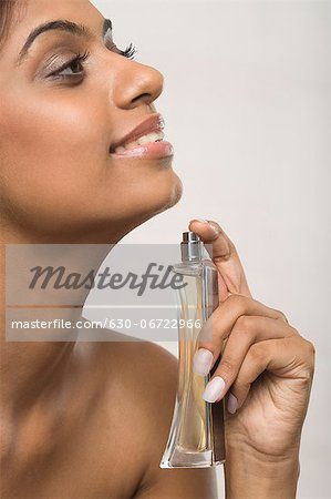 Woman applying perfume