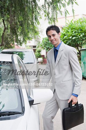 Portrait of a businessman getting into a car