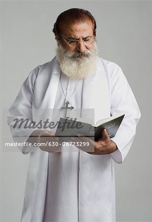 Priest reading a holy book