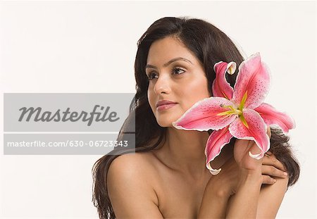Close-up of a woman holding a Tiger Lily flower