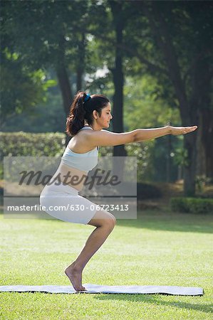 Woman doing Utkatasana (Chair Pose)