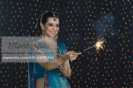 Woman celebrating Diwali festival with a sparkler