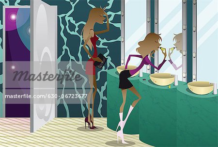 Two women applying make-up in a bathroom