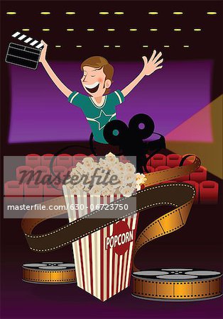 Man holding a film slate in a movie theater with popcorn