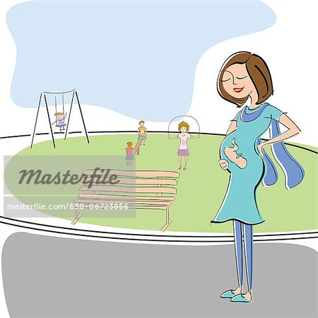 Pregnant woman walking in a park