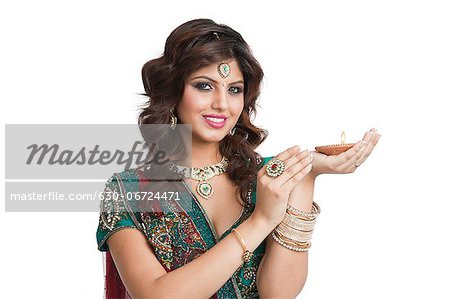 Woman holding an oil lamp on Diwali