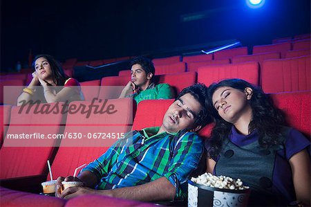 Couple sleeping in a cinema hall
