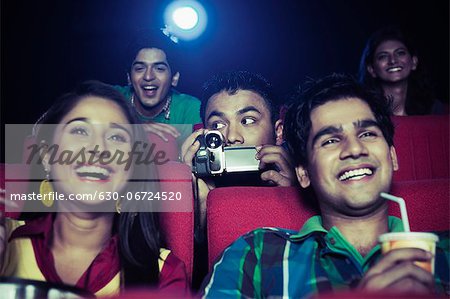 Man using video recorder in a cinema hall