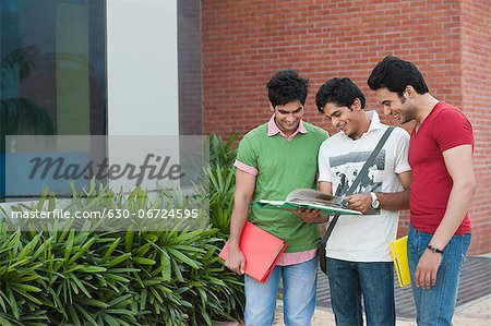 University students reading a book in university campus