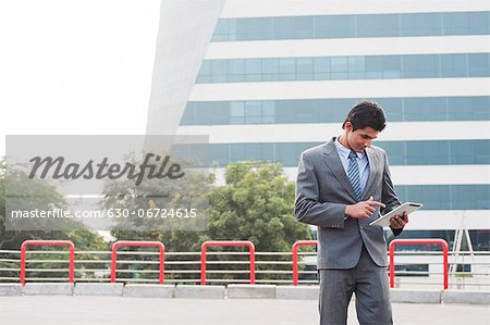 Businessman using a digital tablet, Gurgaon, Haryana, India