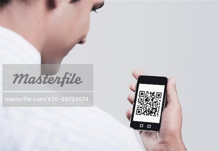 Man looking at the 2D Barcode on a mobile phone