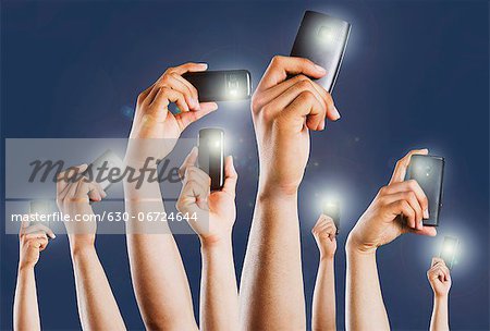 People's hands taking picture with mobile phones