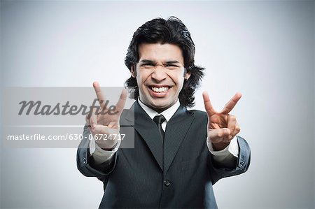 Businessman showing victory sign with his both hands