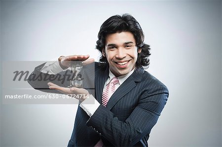 Businessman holding an hourglass
