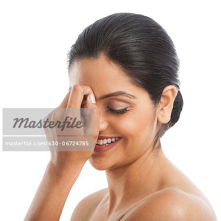 Woman covering her face with her hands and smiling