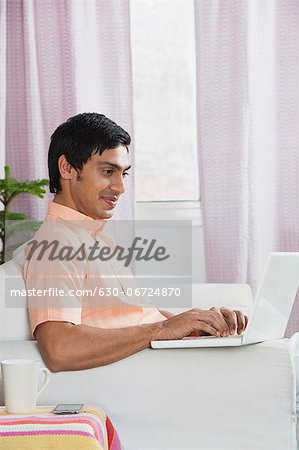 Bengali man using a laptop