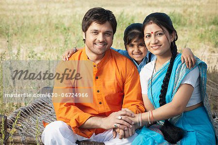 Portrait of a farmers family smiling, Sohna, Haryana, India