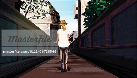 Rear view of woman riding bicycle