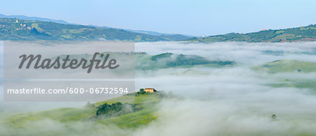 Typical Tuscany landscape with farm in morning with fog near Pienza. Pienza, Siena district, Tuscany, Toscana, Italy.