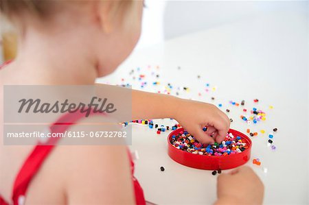Girl Playing With Ironing Beads