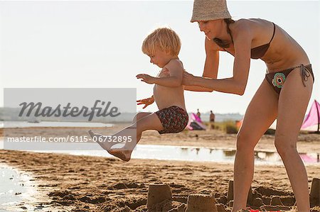 Croatia, Dalmatia, Mother And Son On Sandy Beach