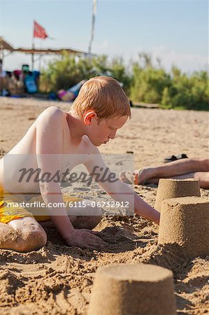 Croatia, Dalmatia, Boy On Beach Building Sandcastle