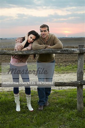 Young Couple Leaning On Wooden Fence, Baranja, Croatia, Europe