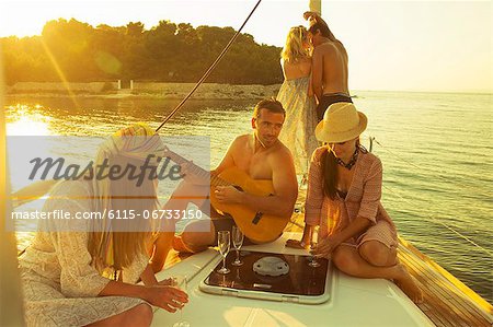 Croatia, Adriatic Sea, Young people on boat celebrating together