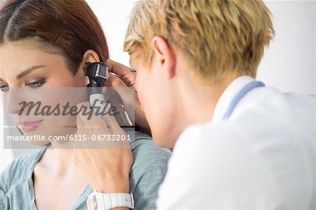 ENT physician Examining the Ear from Female Patient