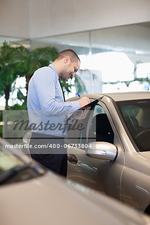 Man holding a folder in a dealership