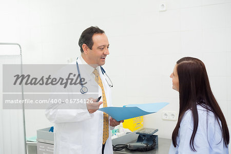 Doctor and patient talking together in an examination room