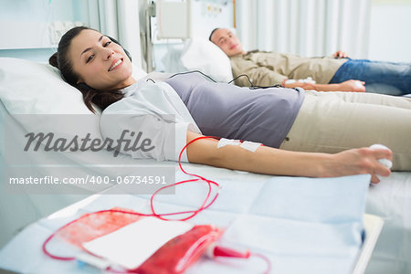 Transfused patients looking at camera in hospital ward