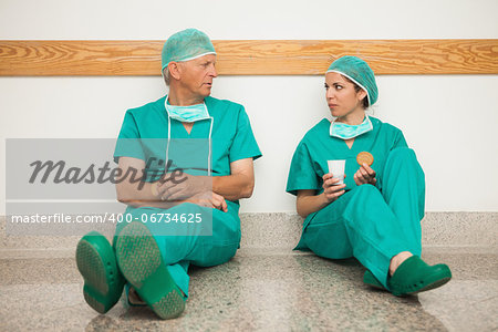 Surgeons having a break in the corridor in a hospital