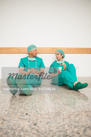 Surgeons sitting on the floor in a hospital