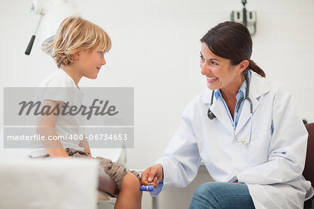 Female doctor auscultating a child in examination room