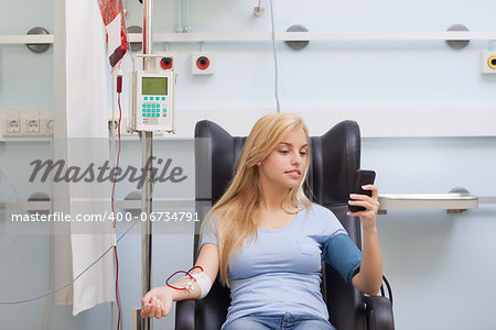 Woman receiving a blood transfusion in hospital ward