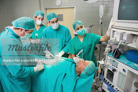 Surgeon looking at a monitor while operating in an operating theatre