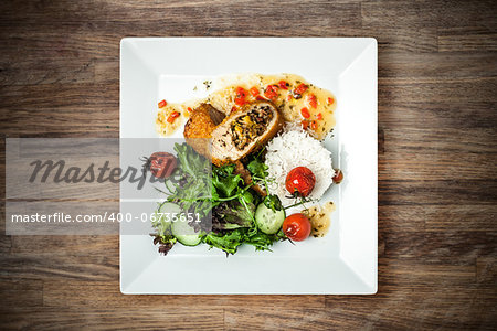 Stuffed chicken fillet with cheese trio, kumquat sauce and nutty rice