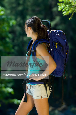 Young woman hiking in summer near Rogue River