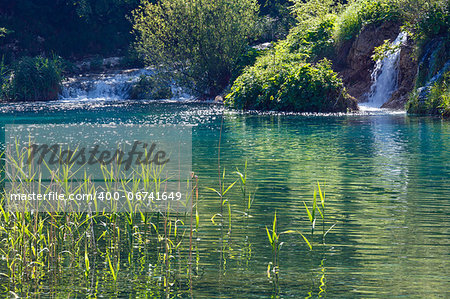 Beautiful summer waterfalls and lake with canes in Plitvice Lakes National Park (Croatia)