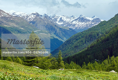 Summer mountain cloudy landscape with snow on mount top (Alps, Switzerland)