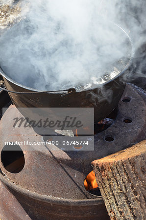 The process of boiling maple sap to create maple syrup,  using a traditional method.