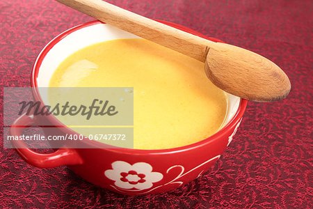pumpkin soup in red bowl