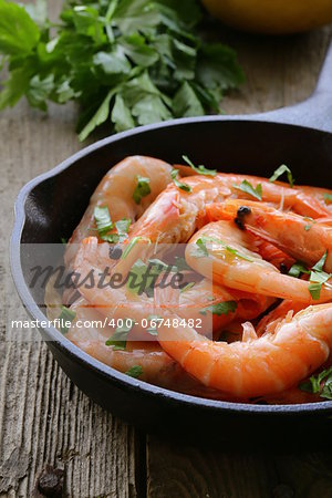 shrimp fried with herbs and spices in a pan