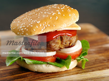 Photo of a hamburger on a wooden board.